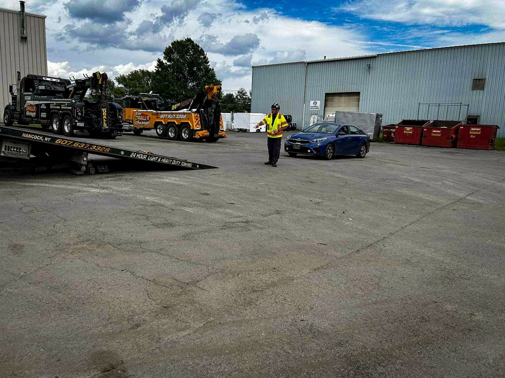 Tow Truck Operator Training – Outdoor Vehicle Recovery Scenario Tow Truck Operator Training outdoor scenario with flatbed setup and vehicle recovery supervision